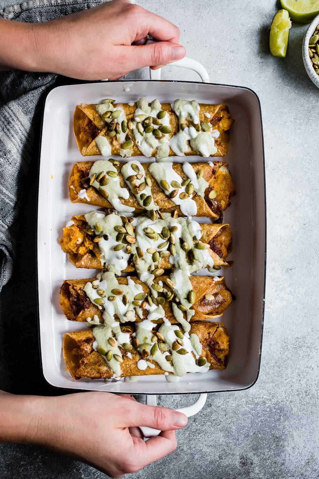 Cheesy Pumpkin Taquitos with Roasted Jalapeno Pepita Crema