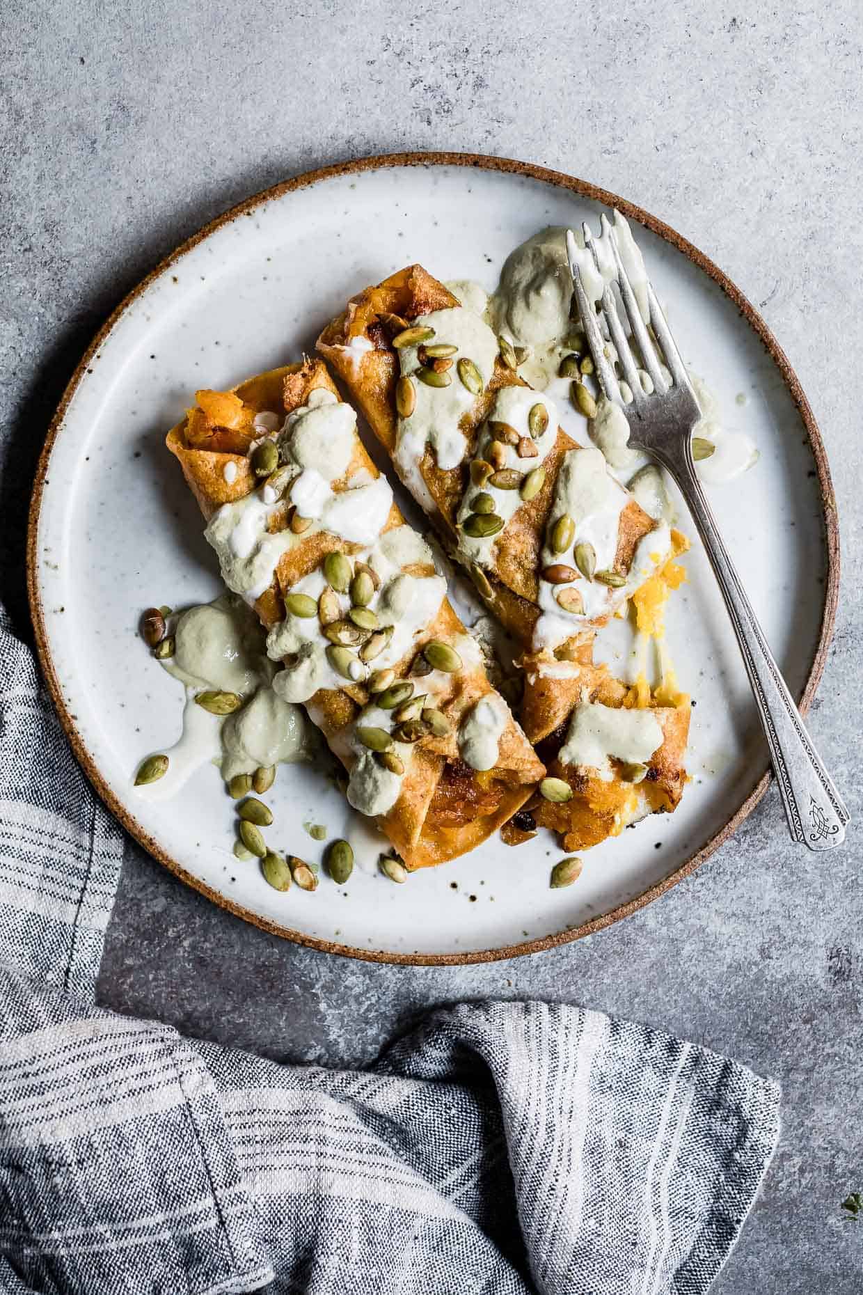 Cheesy Pumpkin Taquitos with Roasted Jalapeno Pepita Crema