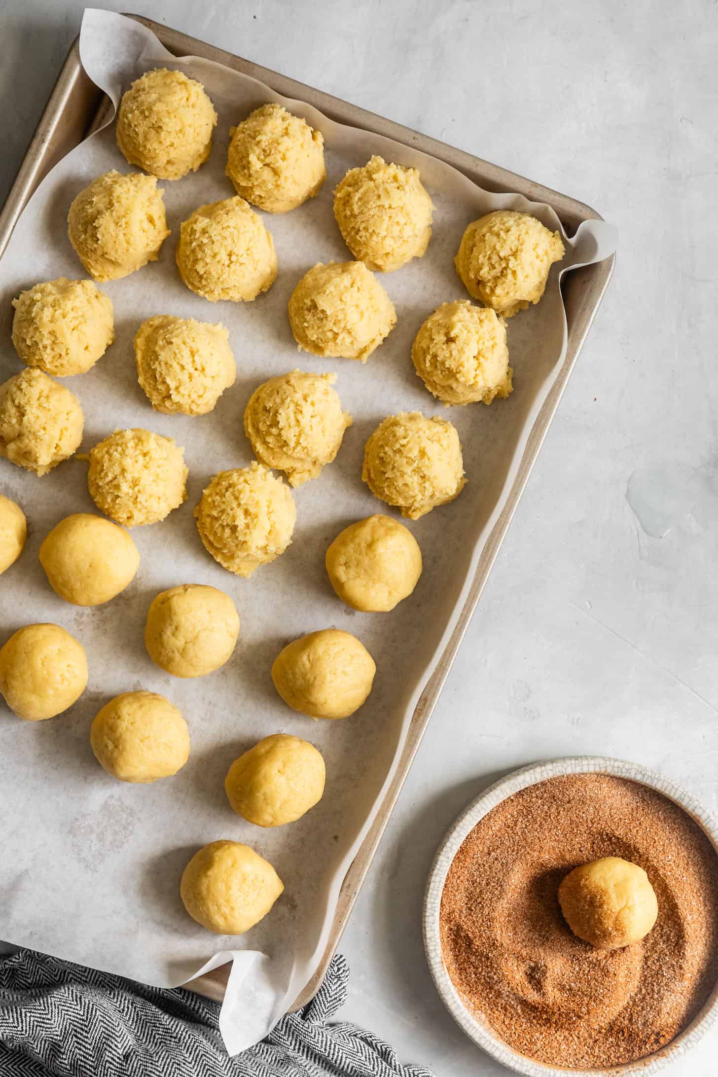Rolling Snickerdoodles in Cinnamon Sugar