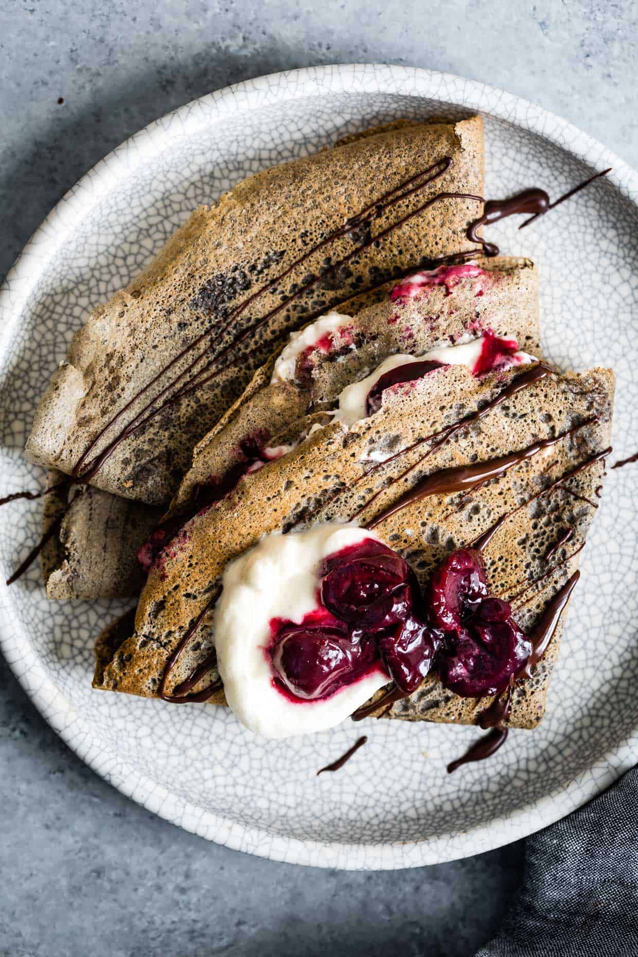 Buckwheat Crepes with Roasted Cherries, Whipped Cream, and Chocolate