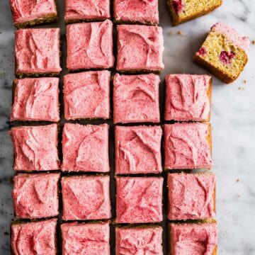 Delicious raspberry lemon cake squares with pink frosting, perfect for dessert or tea time.