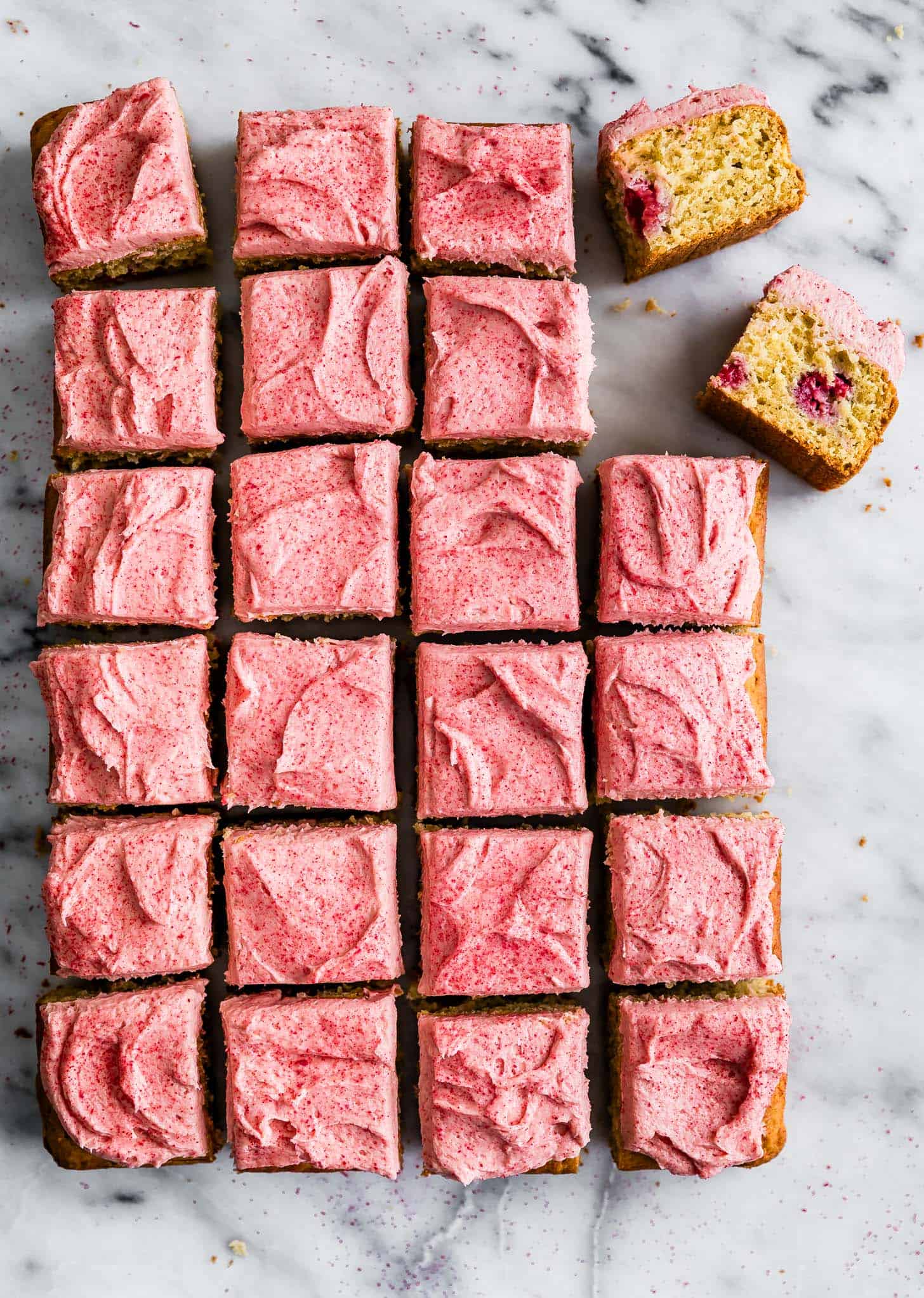Delicious raspberry lemon cake squares with pink frosting, perfect for dessert or tea time.