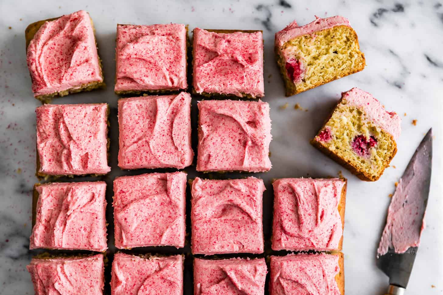 Pieces of gluten-free raspberry cake with raspberry frosting