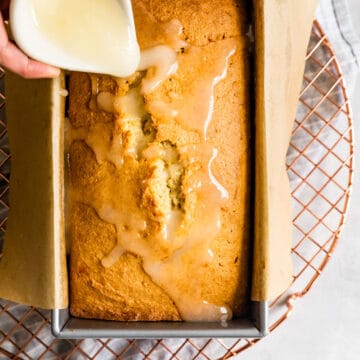 pouring icing over Gluten-Free Lemon Drizzle Cake