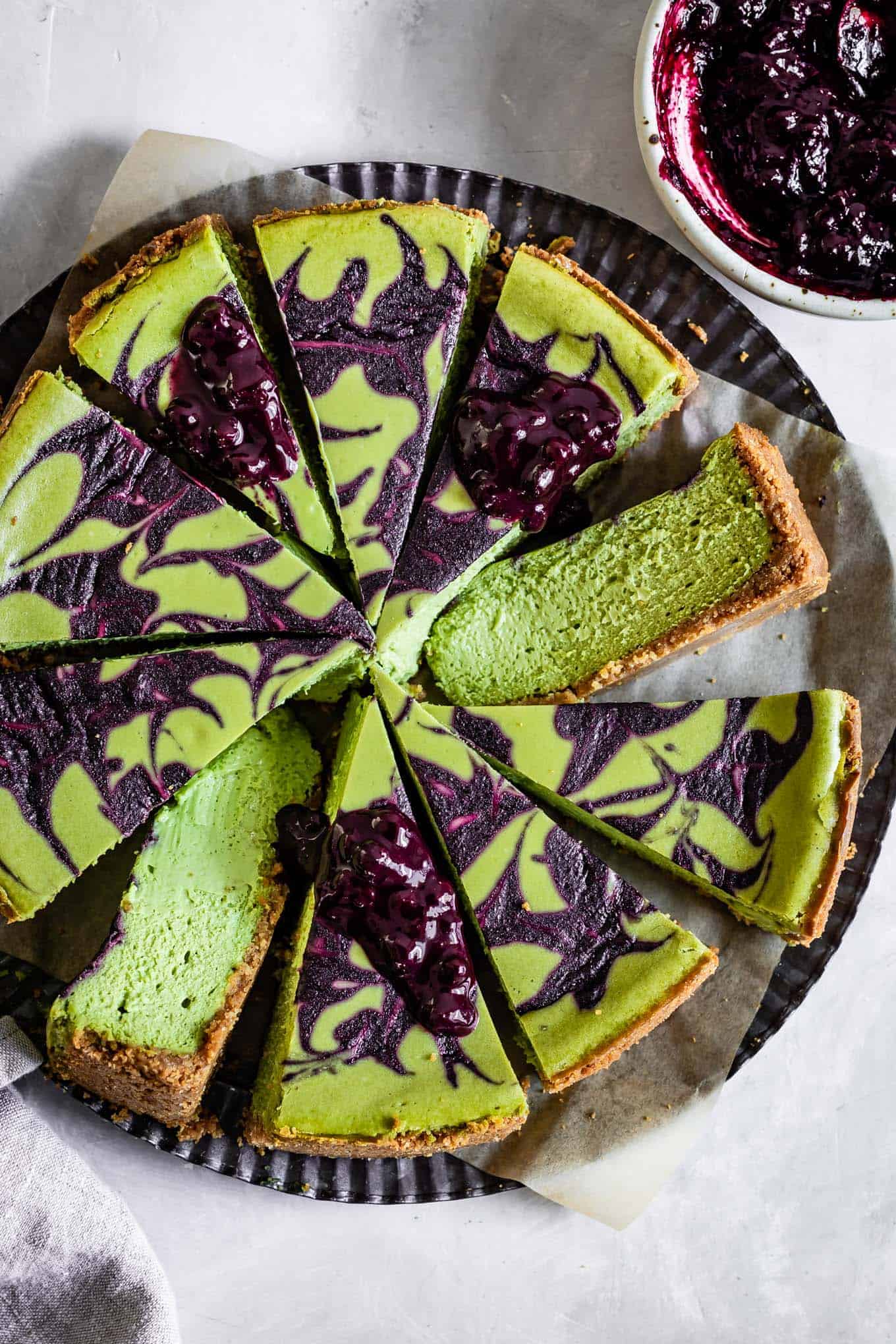 Sliced Matcha Cheesecake with Blueberry Swirl