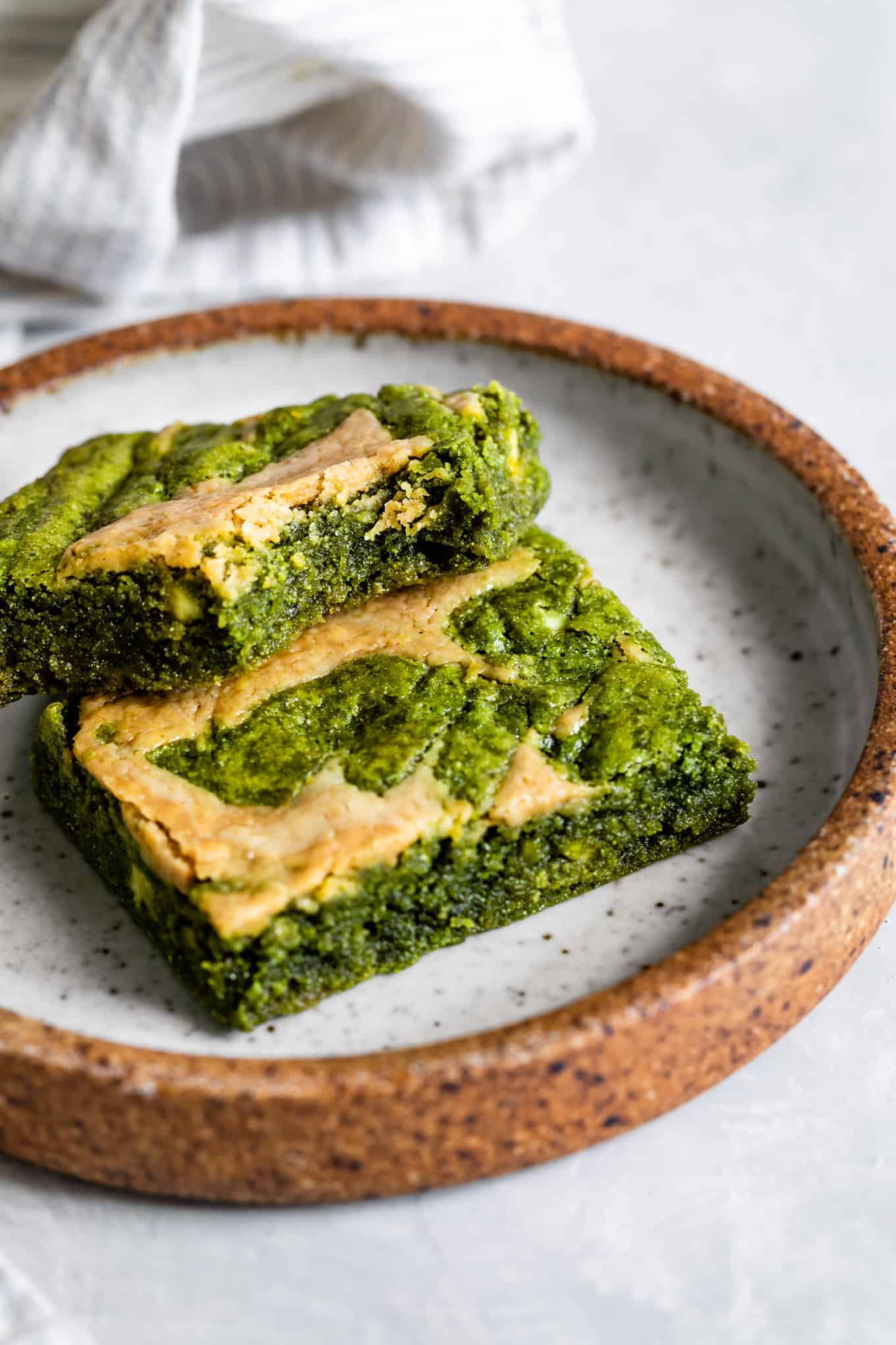 Plate of Gluten-Free White Chocolate Matcha Brownies with Bite