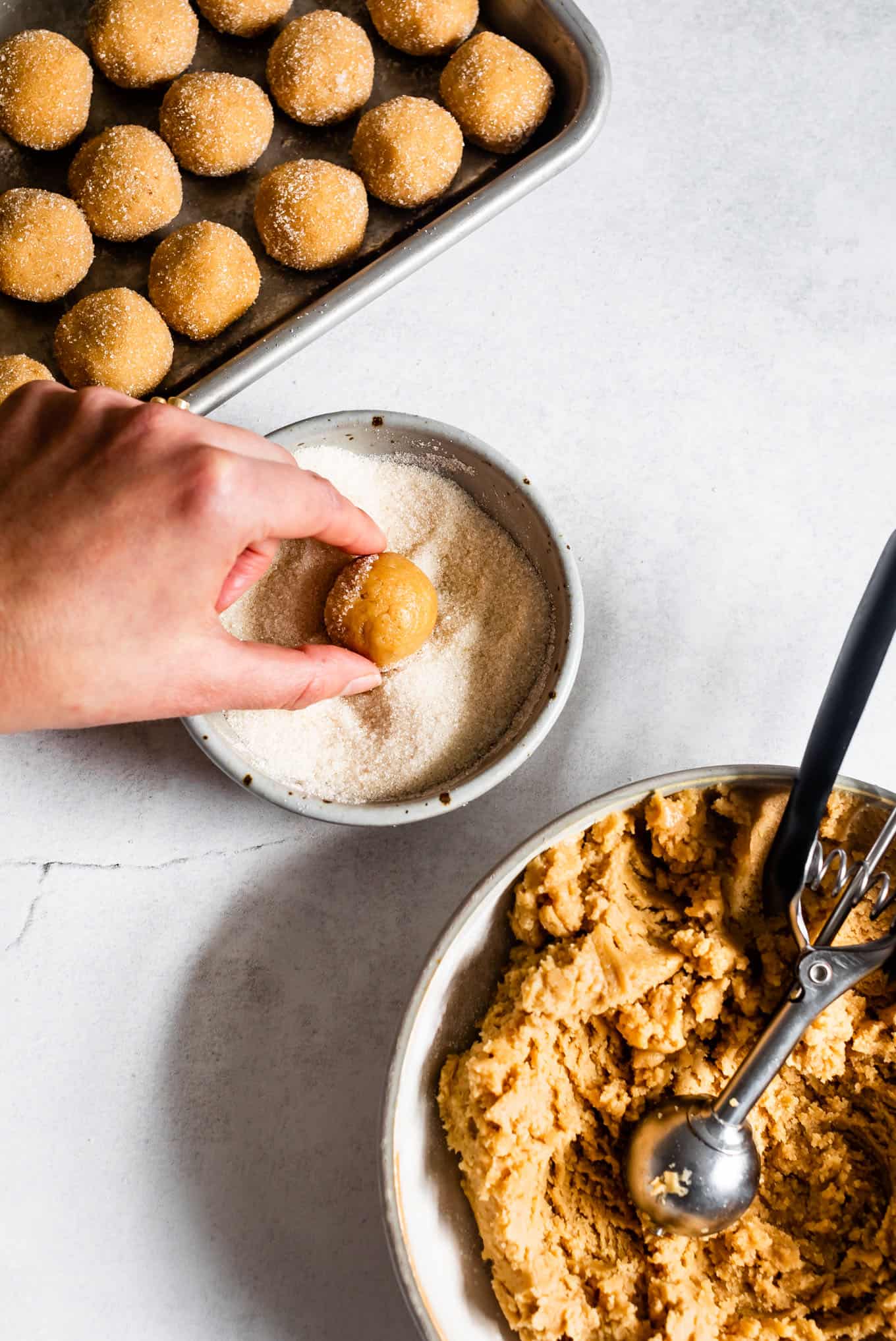 Rolling Peanut Butter Blossoms in Sugar