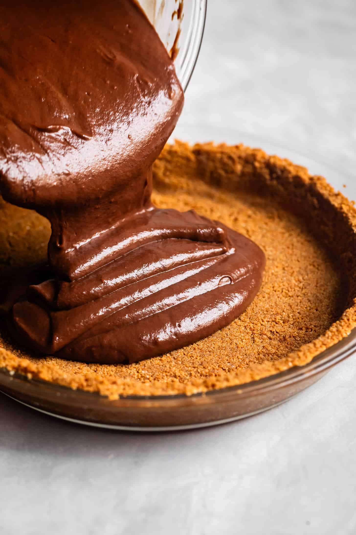 Pouring Chocolate Cream Pie Filling into Graham Cracker Crust