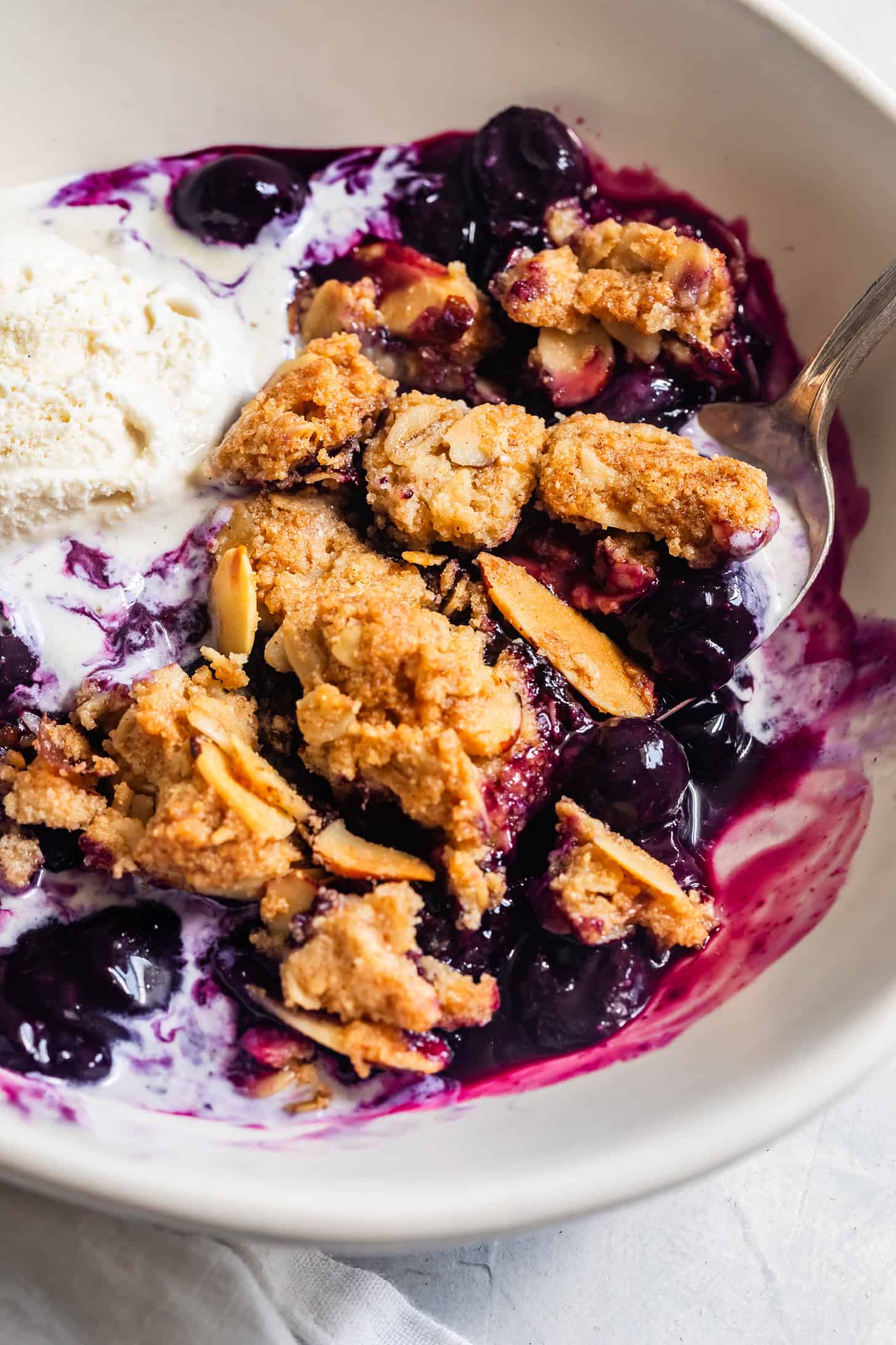 Gluten-Free Blueberry Crisp in a Bowl with Ice Cream