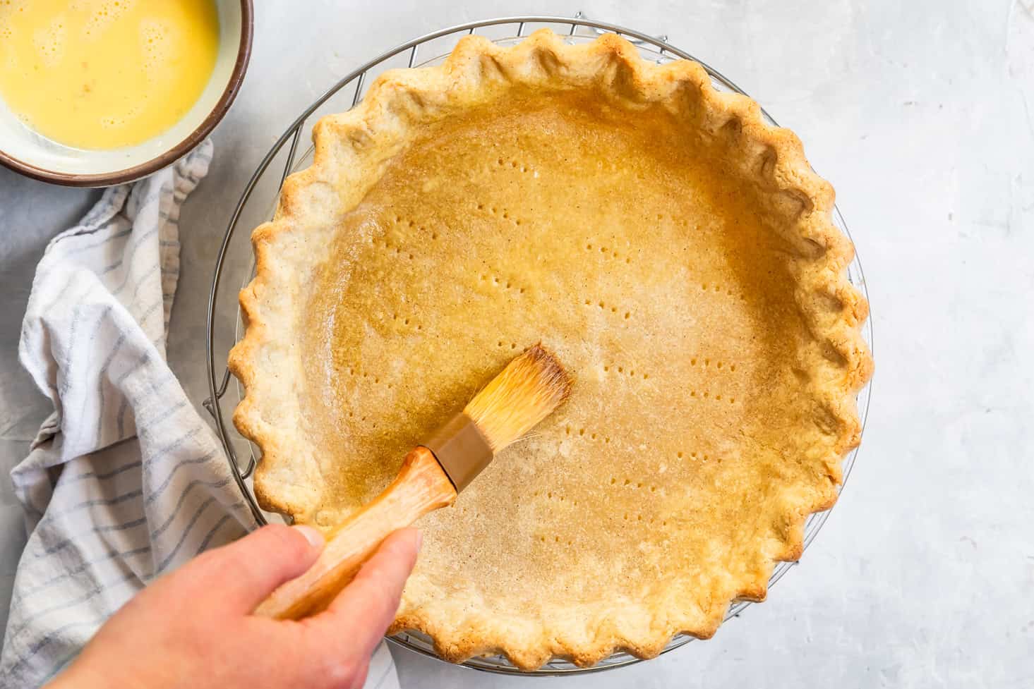 Brushing Gluten-Free Pie Crust with Egg Wash for Blind Baking