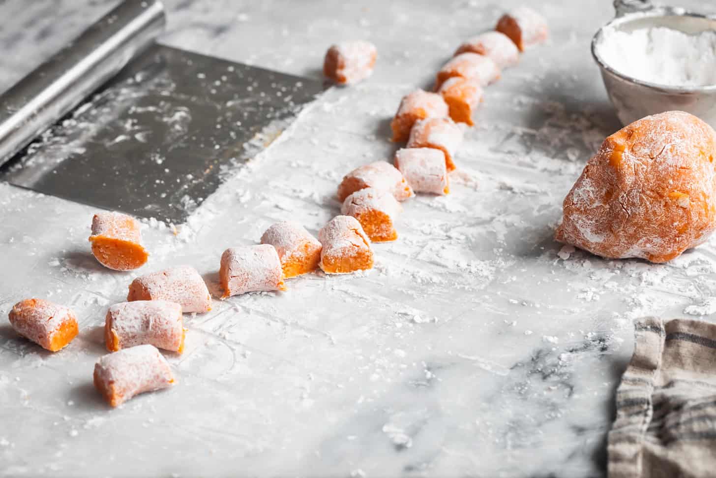 Cutting a piece of sweet potato gnocchi