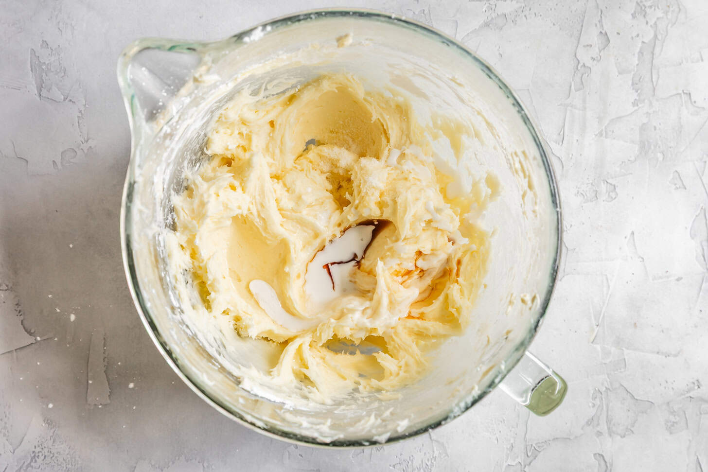 Mixing in coconut extract, vanilla extract, and coconut milk