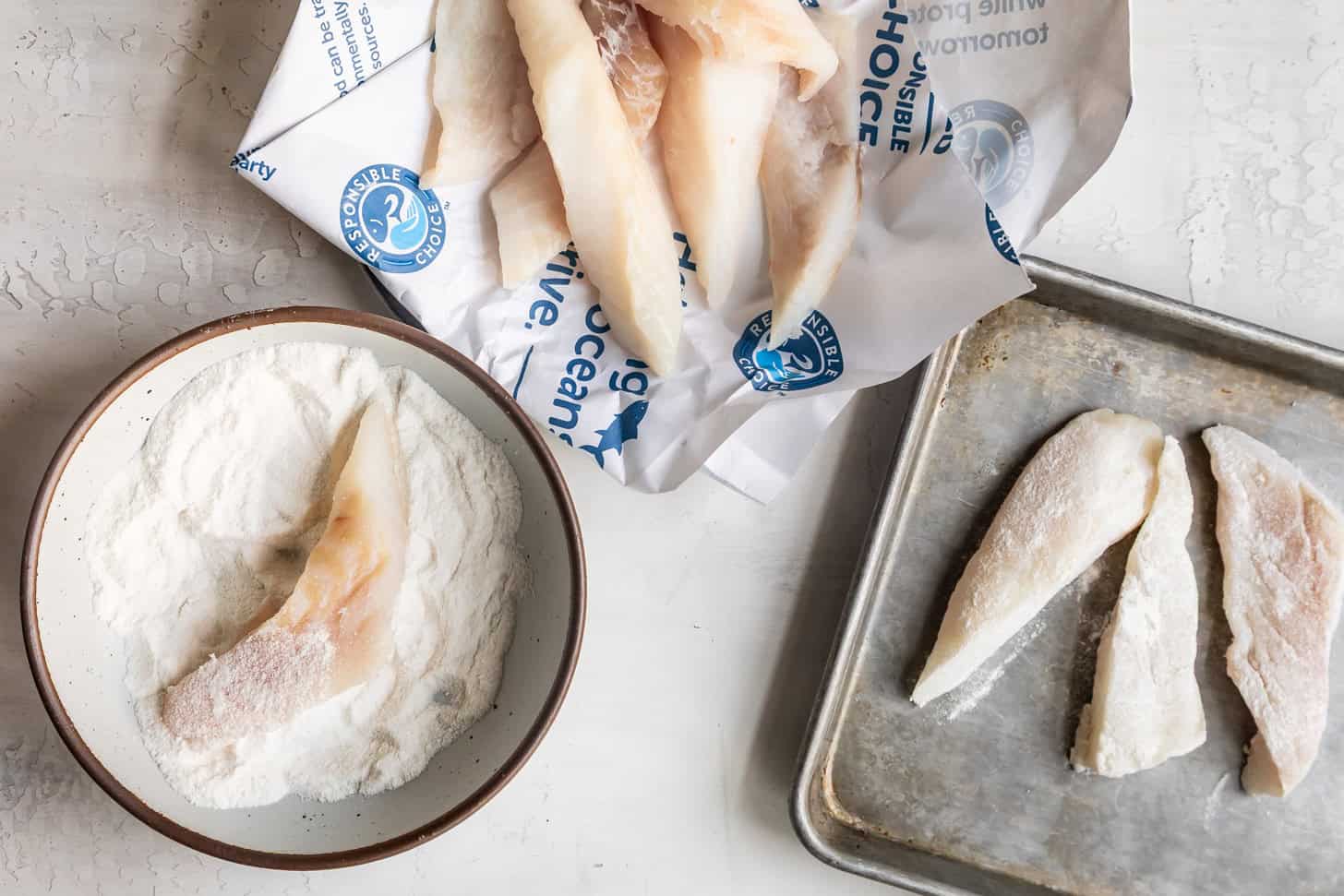 Dredging Fish in White Rice Flour for Frying