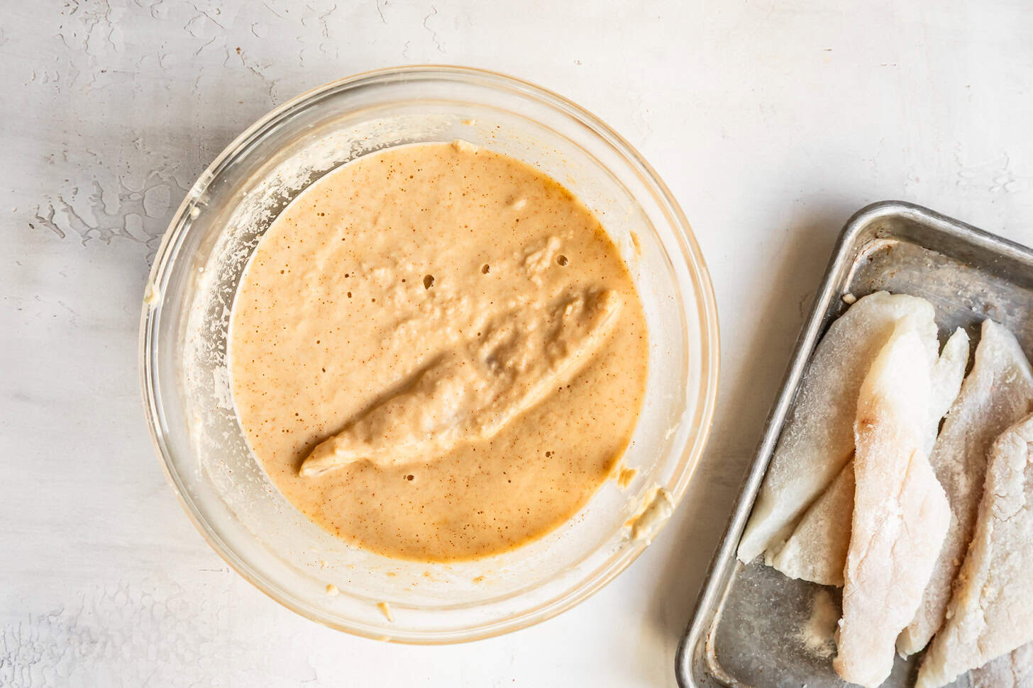 Dunking Fish in Gluten-Free Batter for Frying