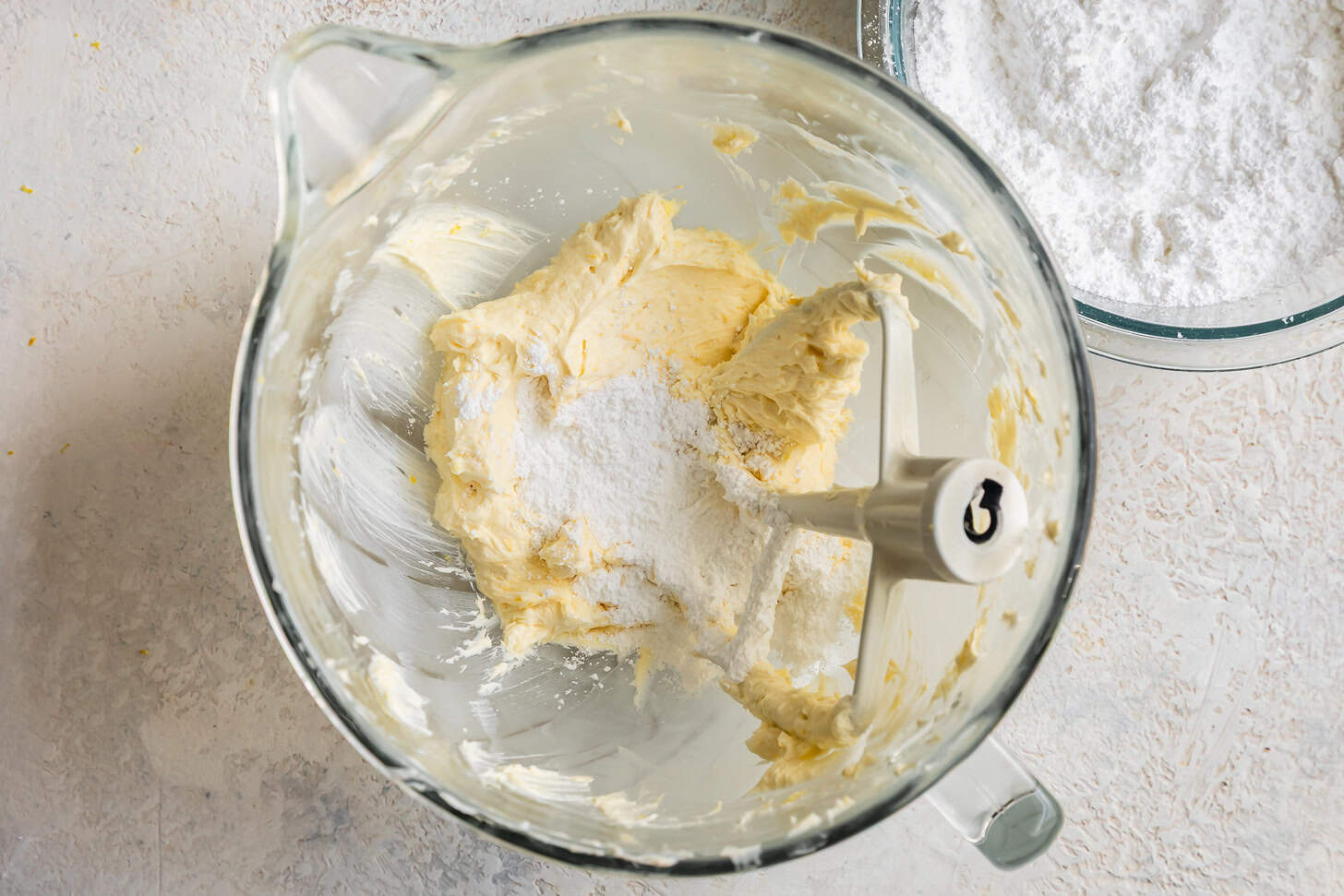 Adding powdered sugar to lemon frosting