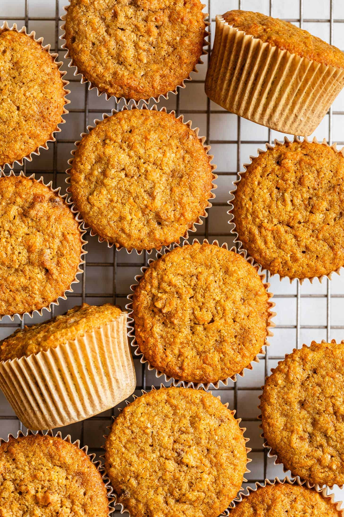 Baked unfrosted gluten-free carrot cupcakes on wire rack