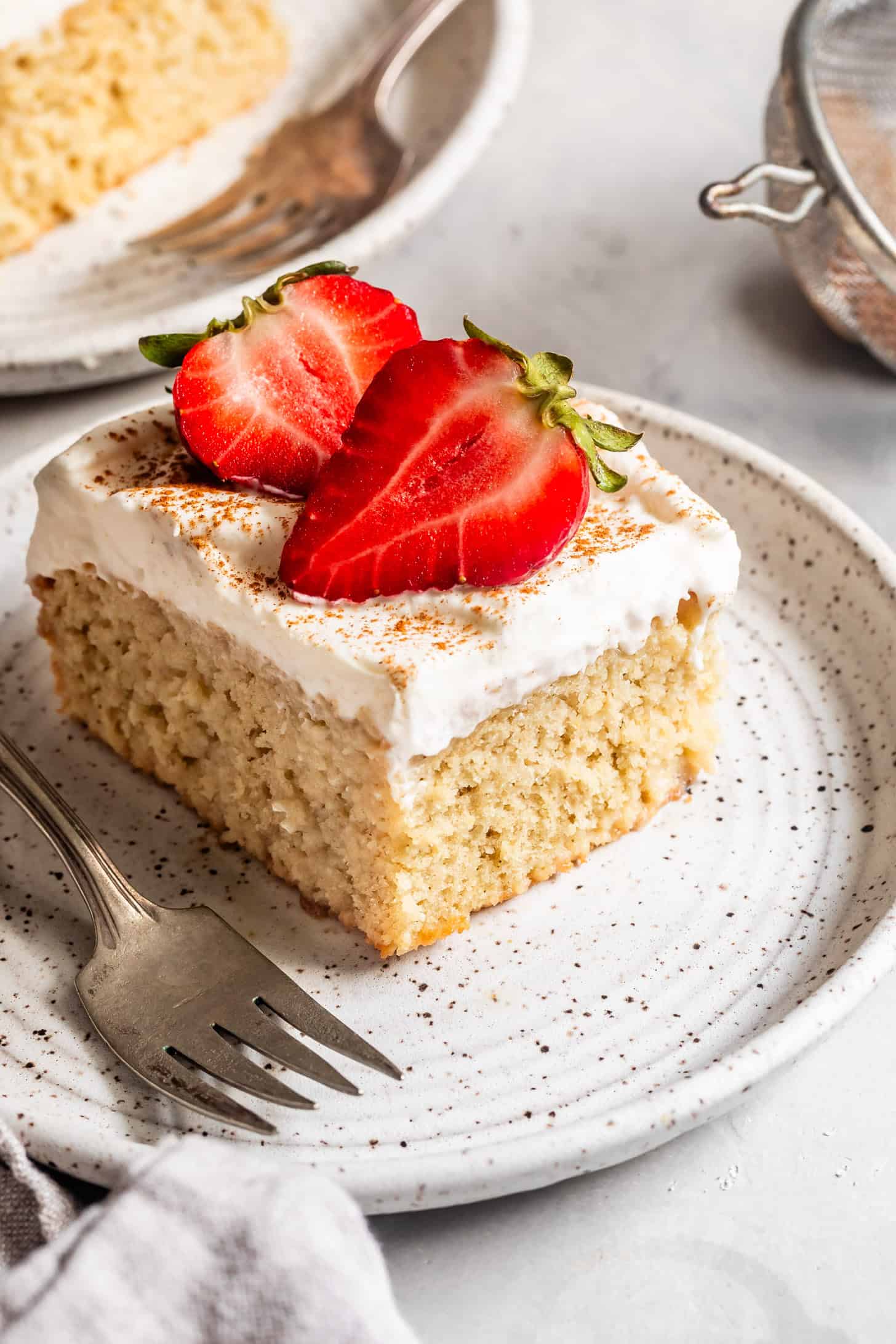 Slice of Gluten-Free Tres Leches Cake on Plate with Strawberries