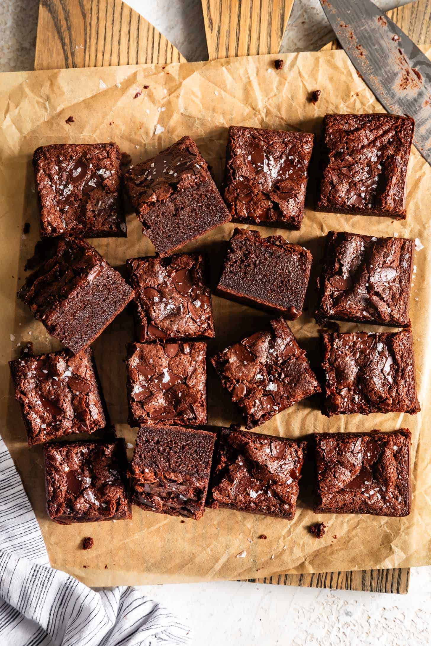 Several Chewy Mochi Brownies on Parchment Paper with Cut side Showing