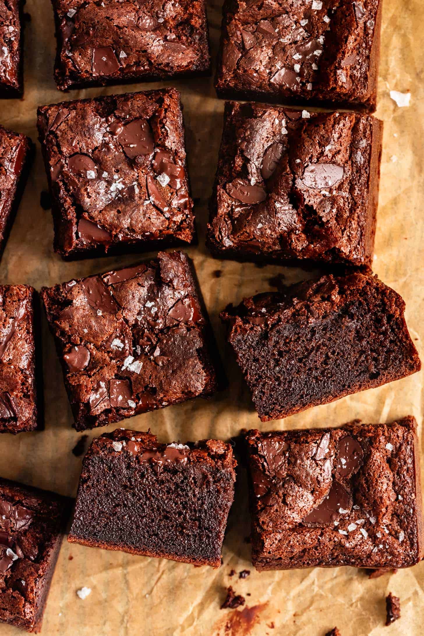 Close-up of Several Chewy Mochi Brownies on Parchment Paper with Cut Side Showing