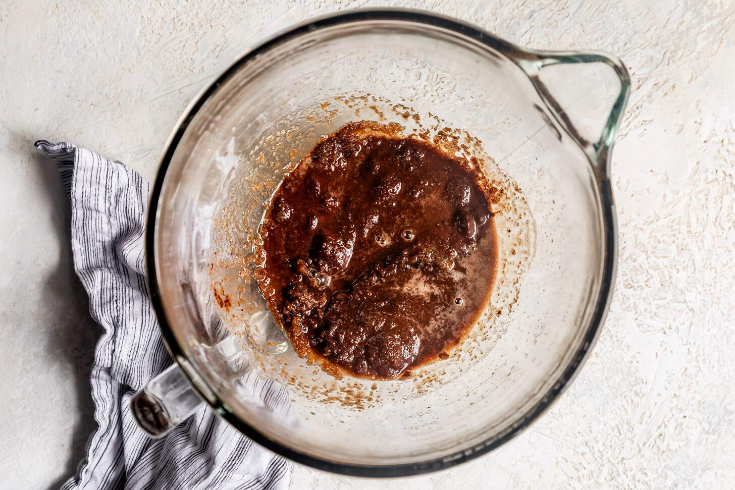 Melting chocolate and sugar with browned butter in mixer bowl