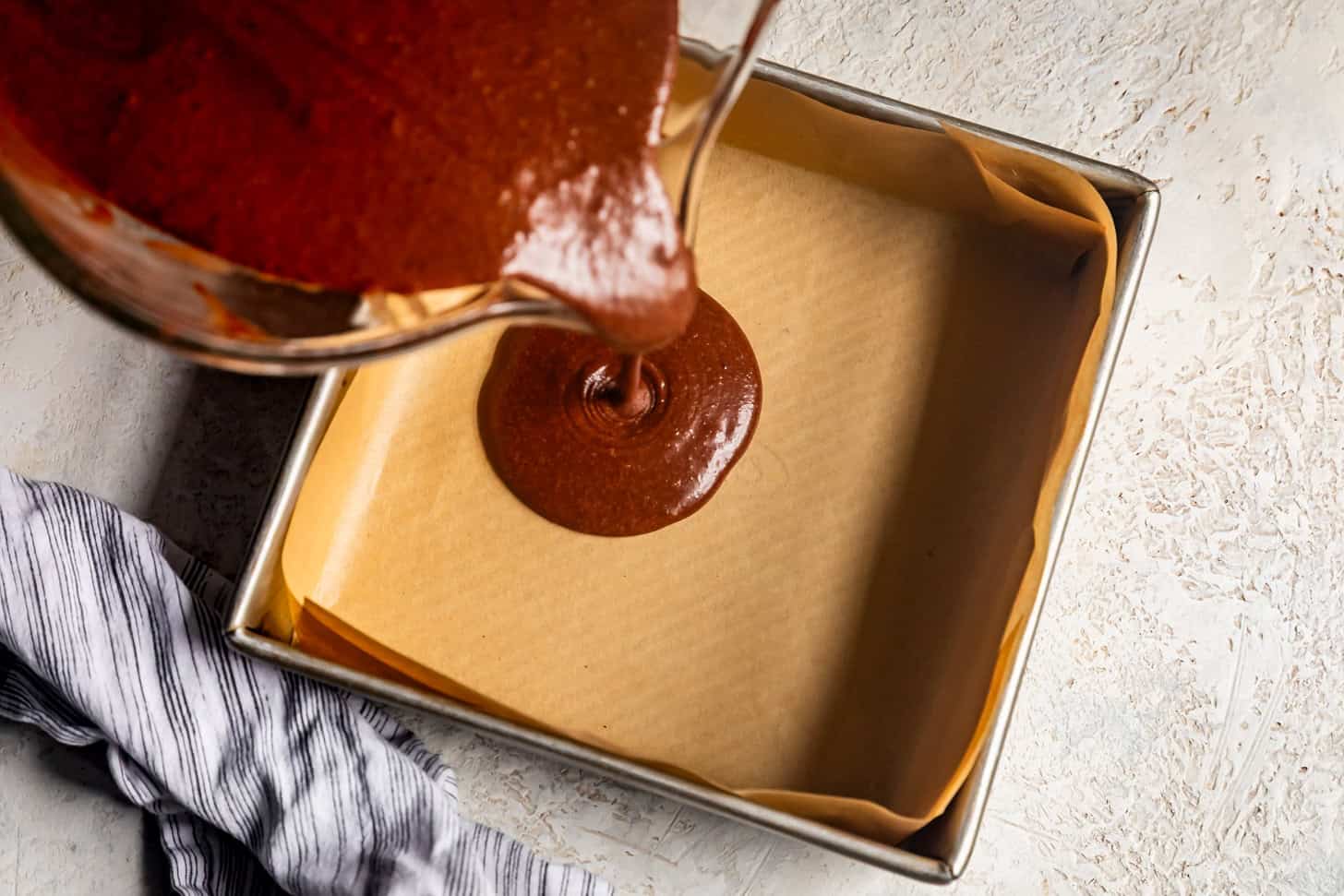 Pouring mochi brownie batter into baking pan