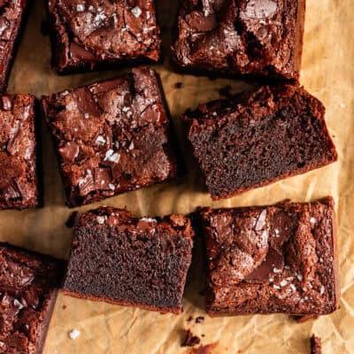 Close-up of Several Chewy Mochi Brownies on Parchment Paper with Cut Side Showing