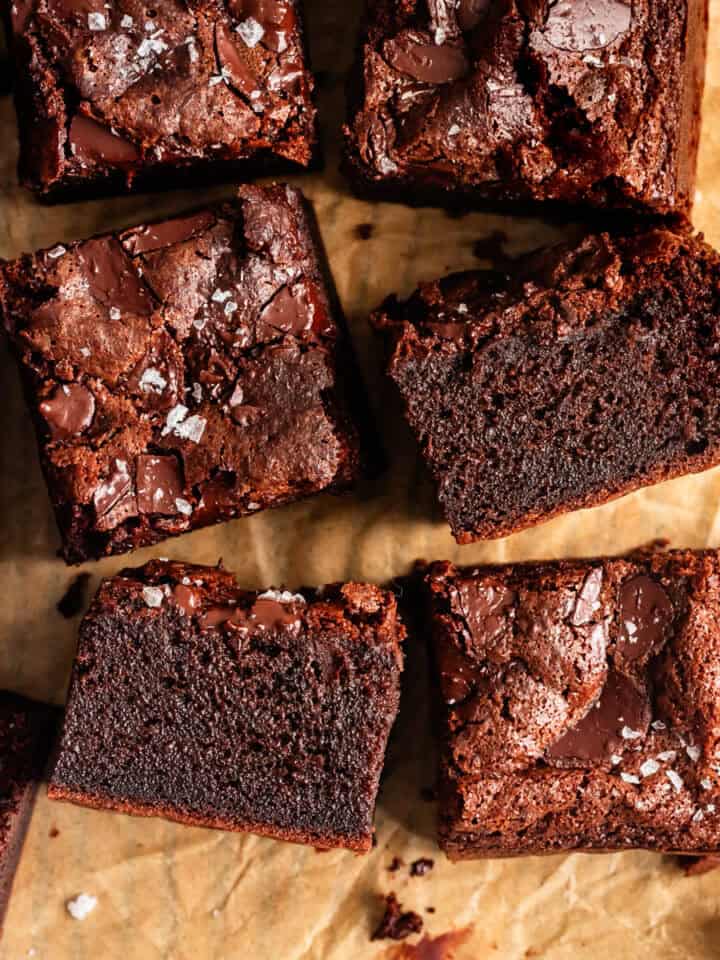 Close-up of Several Chewy Mochi Brownies on Parchment Paper with Cut Side Showing