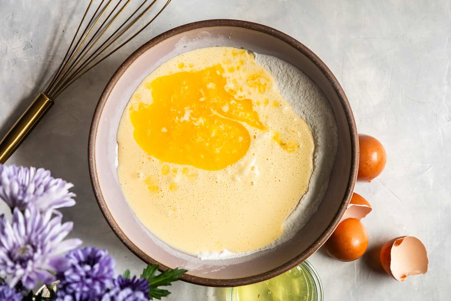 Pouring wet ingredients into dry for mochi pancakes