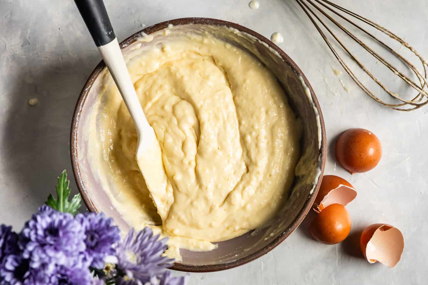Folding egg whites into mochi pancake batter until clumps remain