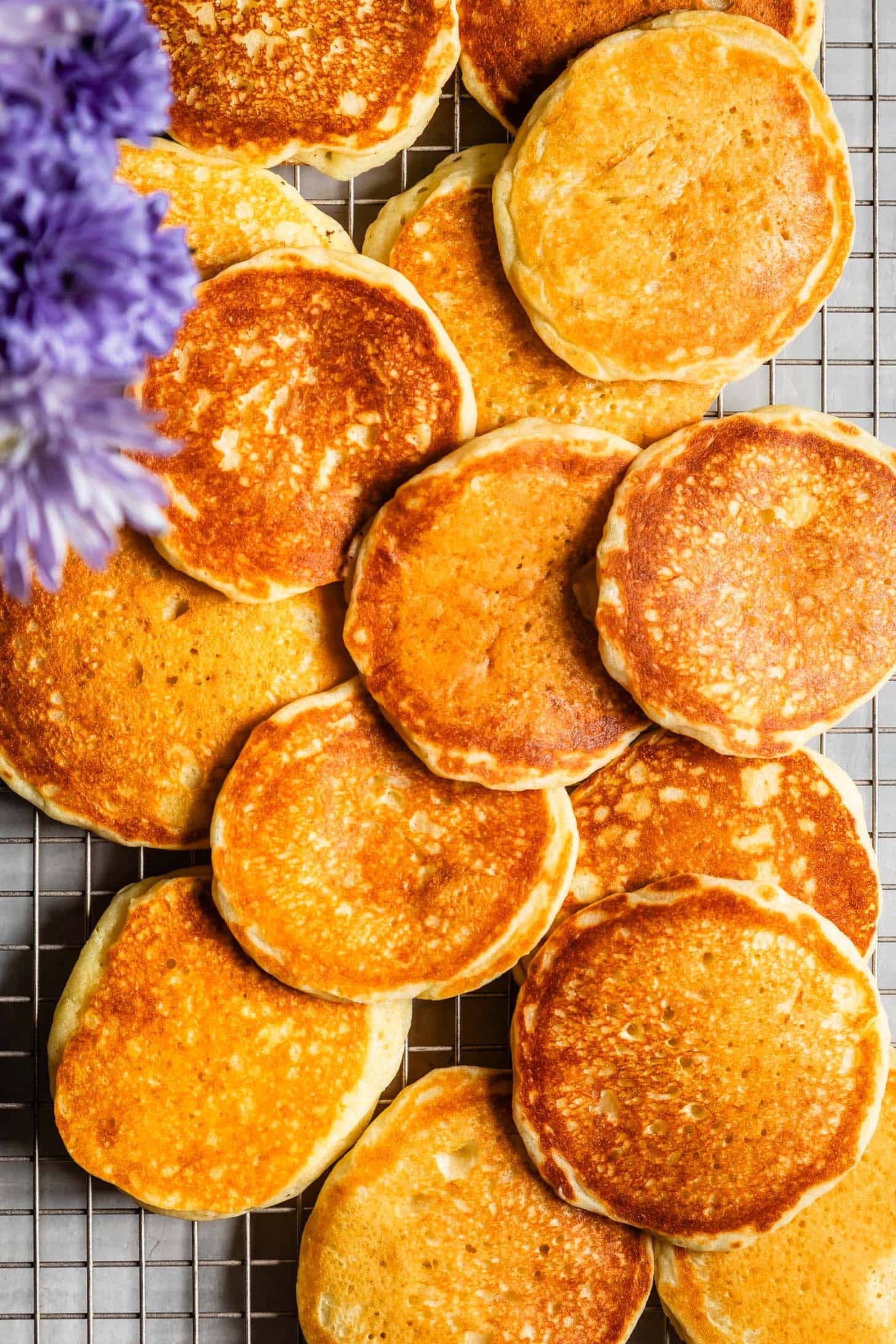 Golden brown mochi pancakes cooling on a wire rack
