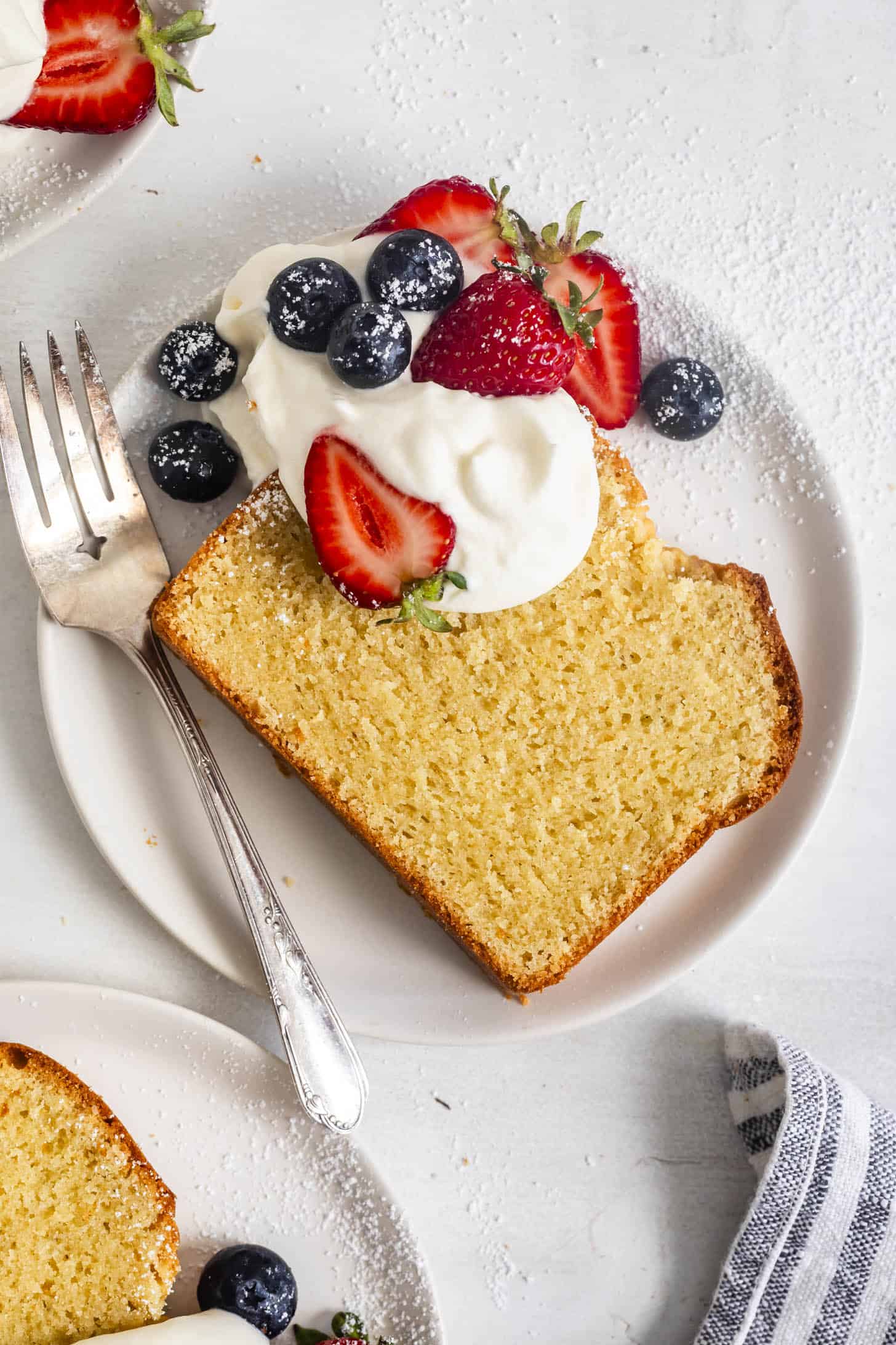 Slice of Gluten-Free Pound Cake with Whipped Cream and Berries