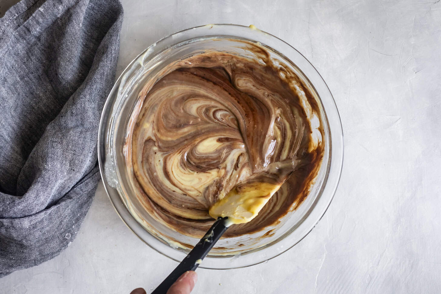 Stirring custard with chocolate for pudding