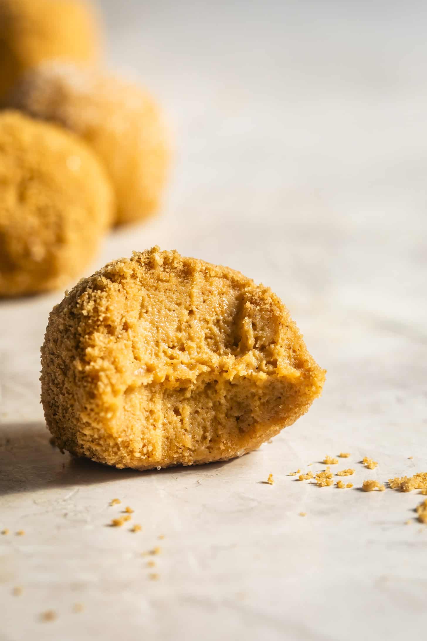 Close-up of bite of one No-Bake Pumpkin Cheesecake Balls