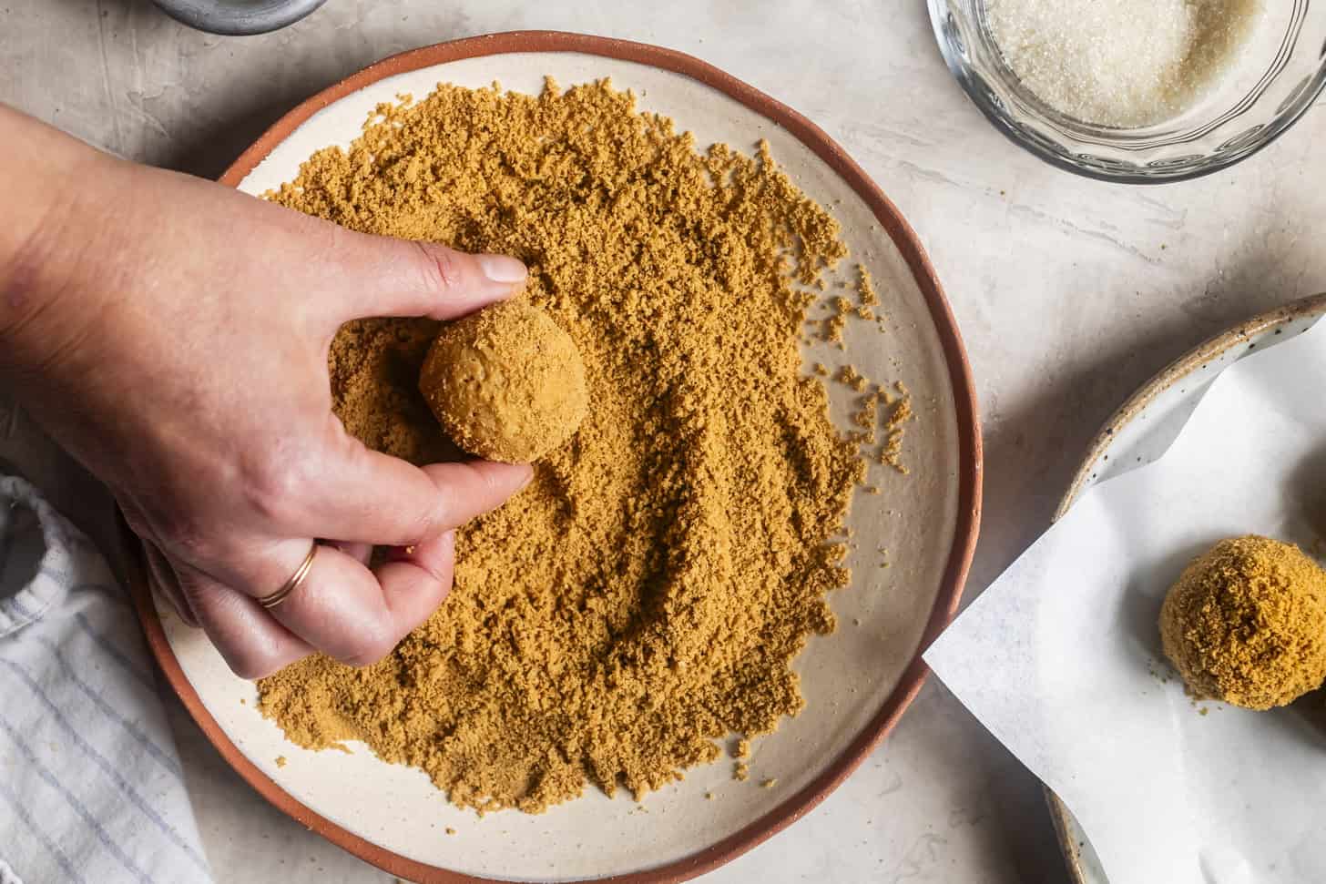 Rolling Pumpkin Cheesecake Bites in Graham Cracker Crumbs
