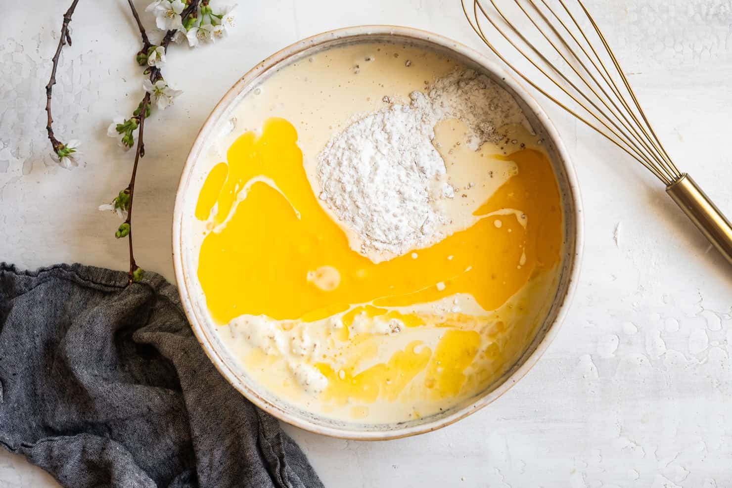 Pouring wet ingredients into dry for mochi waffles
